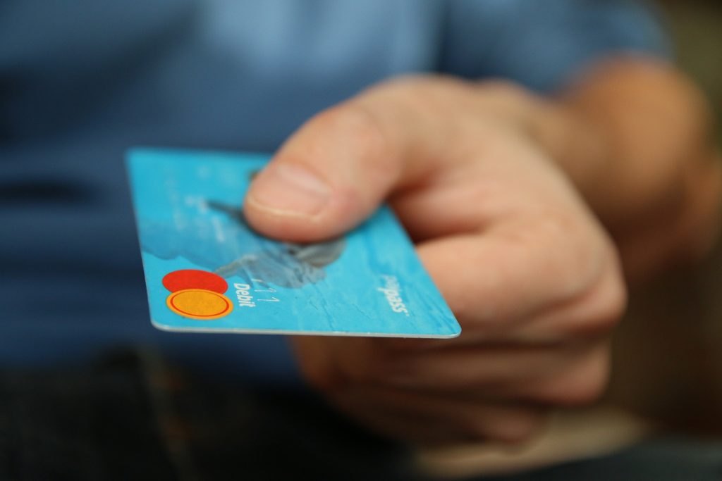 Image of man holding debit card